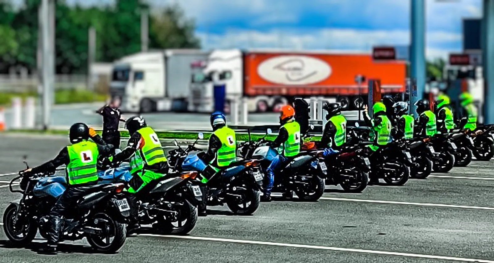 A full IBT class lined up on motorcycles in hi-vis L-plate vests at a Meath Motorcycle Academy training ground